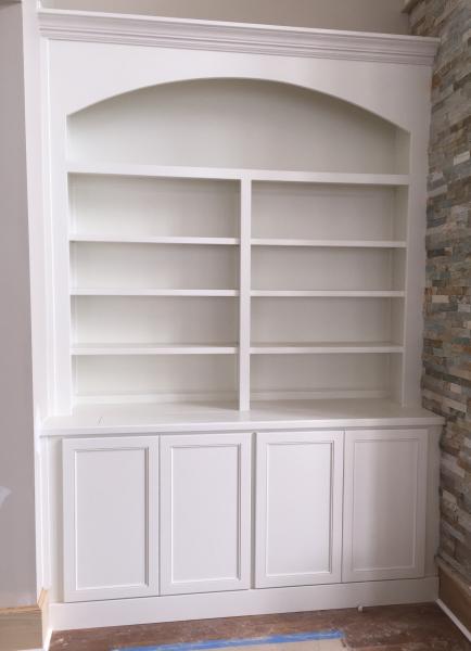 This is a cabinet next to a beautiful fire place. There is actually a TV hidden in the bottom of this unit. It has a remote that flips up a cutout in the top of the wood top and the TV raises up out of the cabinet. This is a number 91 door style and it is painted Pure White.